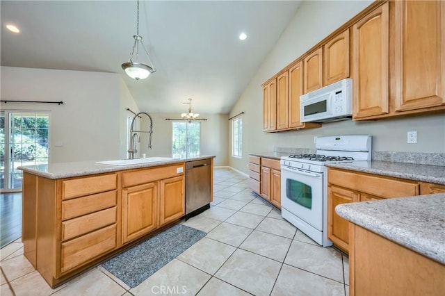 kitchen featuring white appliances, decorative light fixtures, vaulted ceiling, and plenty of natural light