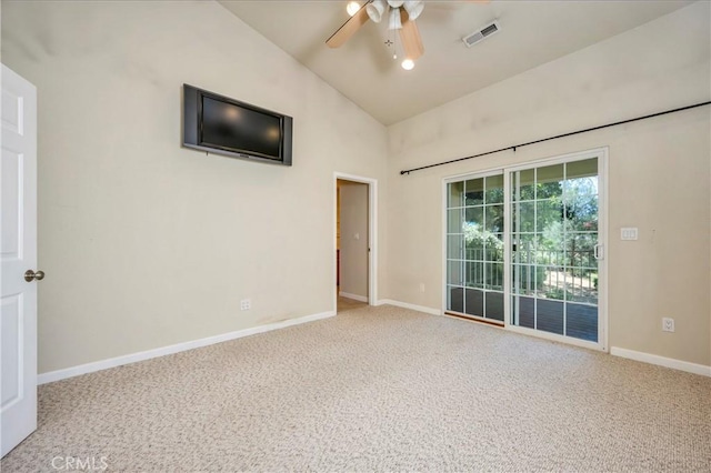 empty room with ceiling fan, carpet floors, and vaulted ceiling