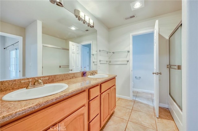 bathroom with shower / bath combination with glass door, tile patterned flooring, and vanity