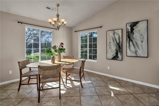 dining space with a notable chandelier, vaulted ceiling, and tile patterned floors