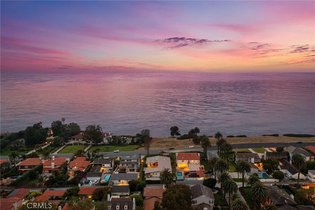 aerial view at dusk with a water view