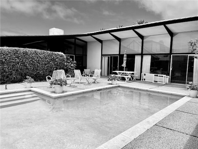 view of patio / terrace featuring glass enclosure