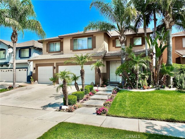 view of front of house with a front yard and a garage