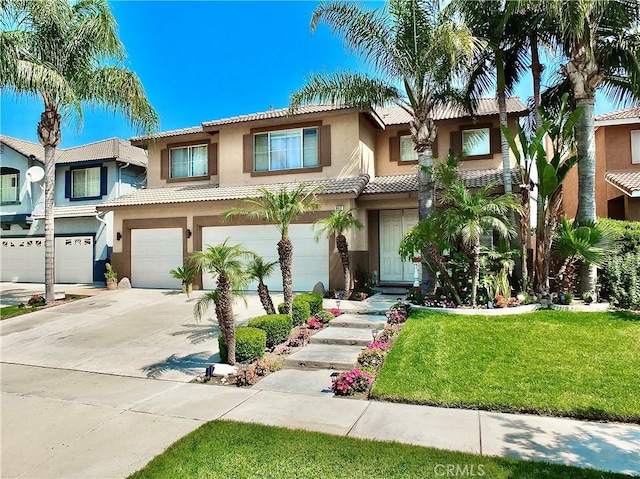 view of front of house with a front yard and a garage