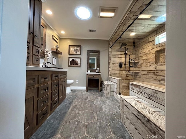 bathroom with a shower, crown molding, vanity, and toilet