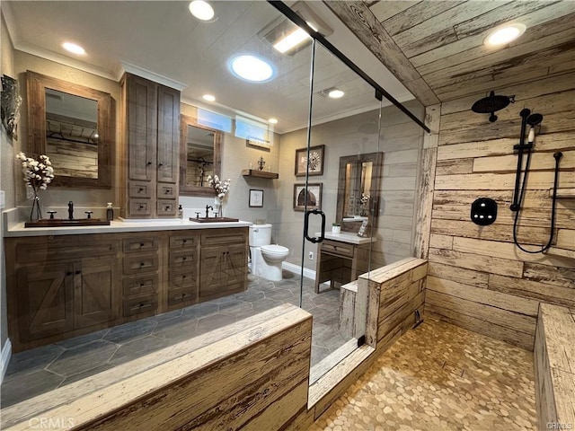 bathroom with wooden walls, vanity, a shower with shower door, and toilet