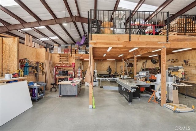 garage with a workshop area and wood walls