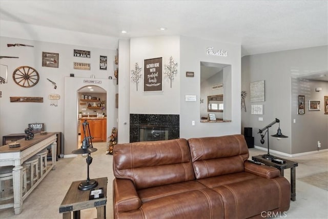 living room with light carpet and a fireplace