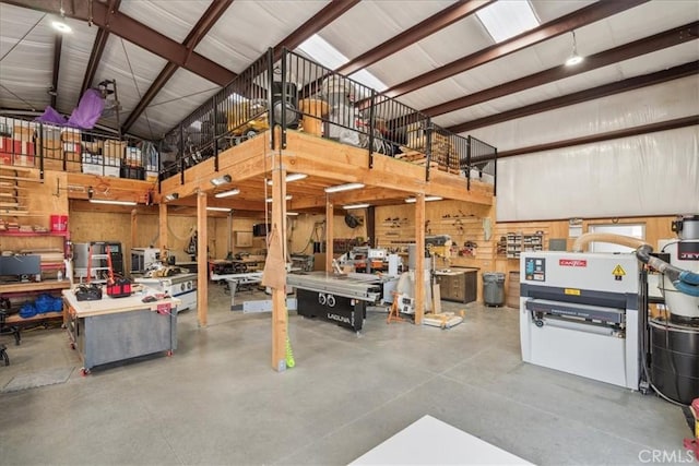 garage featuring a workshop area and wood walls