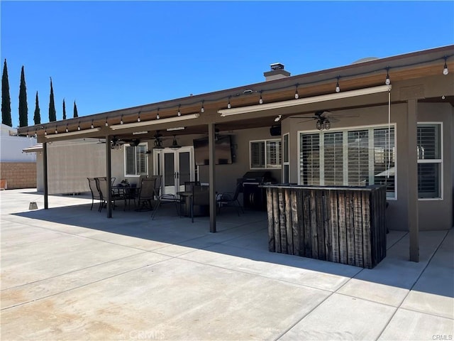 rear view of property featuring a patio and ceiling fan