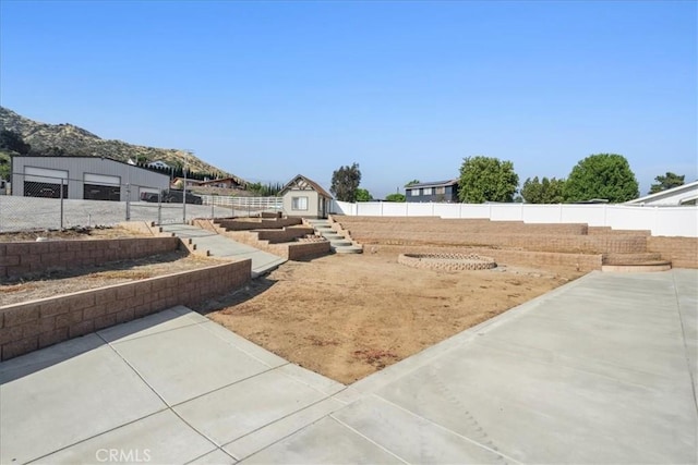 view of yard with a storage shed and a patio