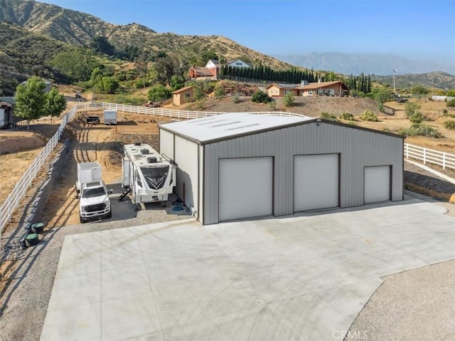 view of outdoor structure featuring a mountain view and a garage