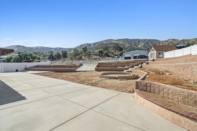 exterior space featuring a mountain view and a patio