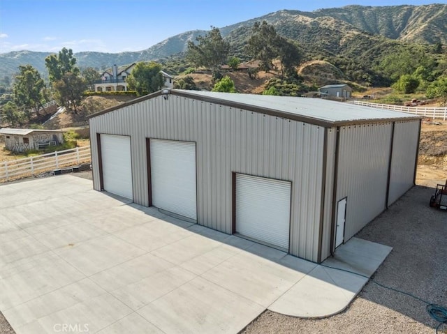 view of outbuilding featuring a mountain view and a garage