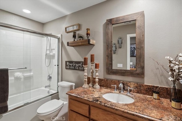 full bathroom with vanity, toilet, and enclosed tub / shower combo