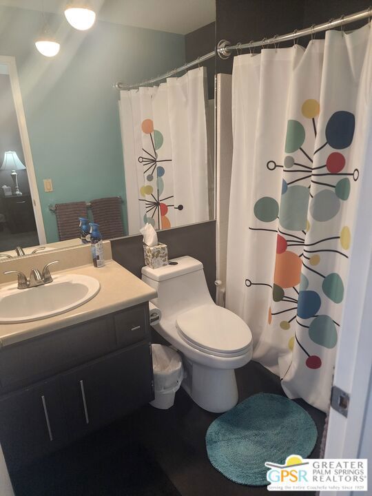 bathroom with vanity, toilet, and walk in shower