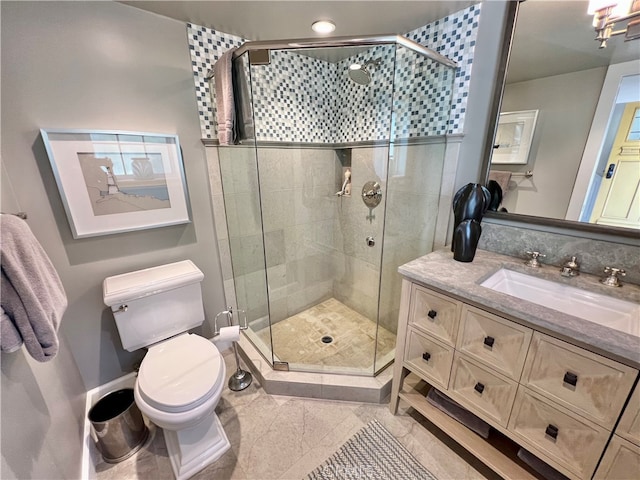 bathroom with tile patterned flooring, toilet, vanity, and an enclosed shower