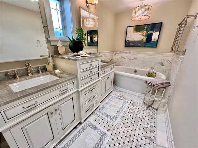 bathroom featuring vanity, tile patterned floors, and a bathtub