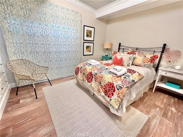 bedroom with light hardwood / wood-style floors and ornamental molding