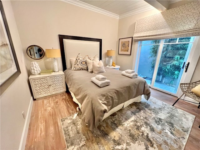 bedroom with ornamental molding, access to exterior, and hardwood / wood-style floors