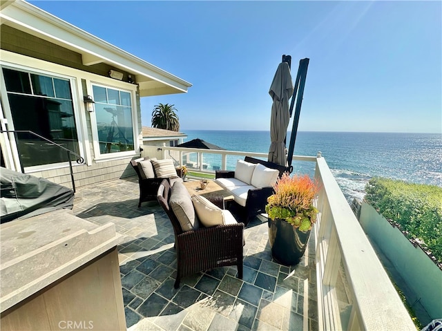 view of patio with a water view and an outdoor hangout area