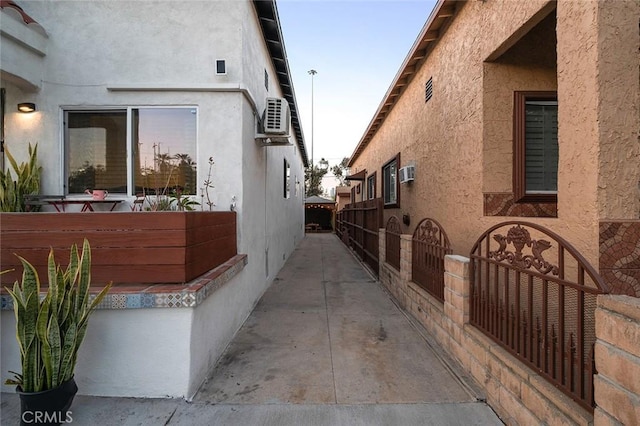view of property exterior featuring a wall mounted AC and stucco siding