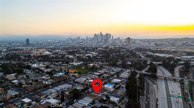 aerial view at dusk featuring a view of city