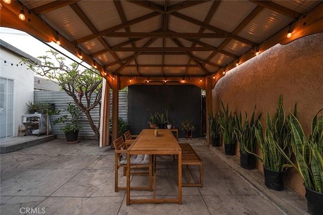 view of patio / terrace with fence, a gazebo, and outdoor dining space