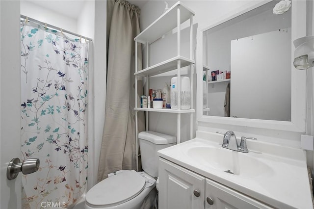 bathroom featuring toilet, vanity, and a shower with shower curtain