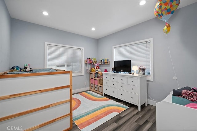 bedroom with baseboards, wood finished floors, and recessed lighting