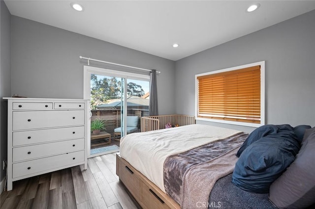 bedroom featuring dark wood-style flooring, access to exterior, and recessed lighting