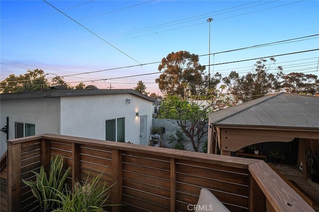 view of property exterior with stucco siding and fence
