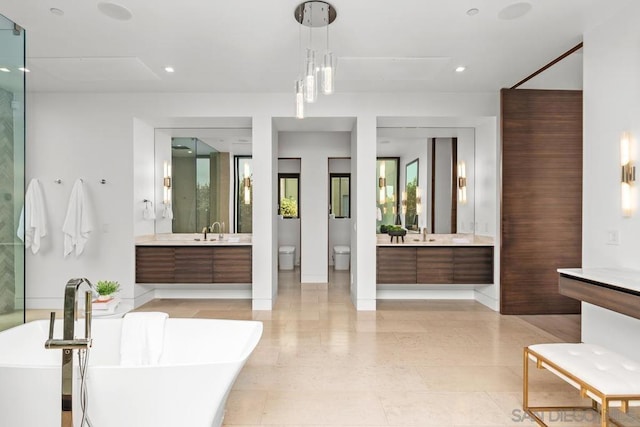 bathroom with a tub to relax in and vanity