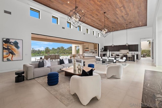 living room with a high ceiling, plenty of natural light, and wooden ceiling