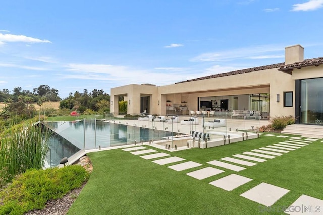 back of property featuring a lawn and a patio area