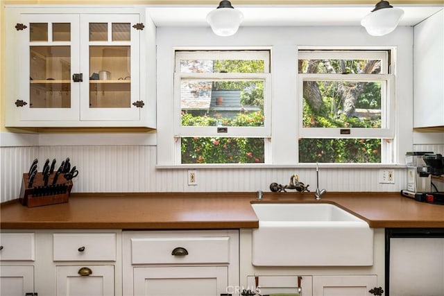 kitchen featuring white cabinetry, sink, and stainless steel dishwasher