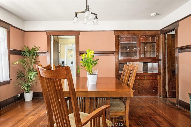 dining room with a chandelier and wood-type flooring