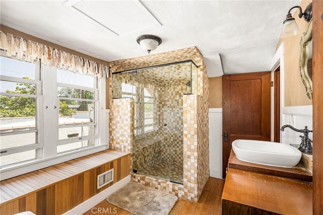 bathroom featuring hardwood / wood-style flooring, sink, and walk in shower