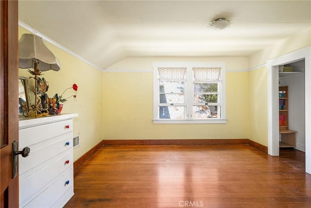 unfurnished bedroom with lofted ceiling and wood-type flooring