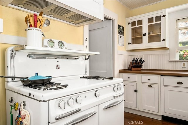 kitchen featuring white cabinetry, extractor fan, and dark hardwood / wood-style floors