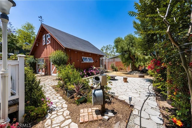 view of yard featuring a patio area and an outdoor structure