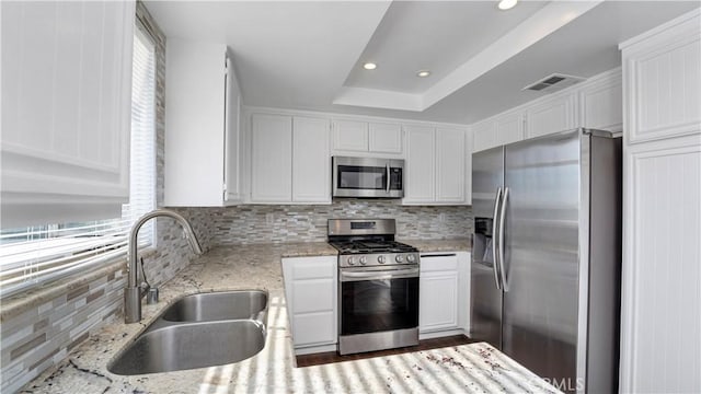 26853 Claudette St Unit 141, Canyon Country, CA 91351 - kitchen featuring appliances with stainless steel finishes, decorative backsplash, white cabinetry, plenty of natural light, and recessed lighting