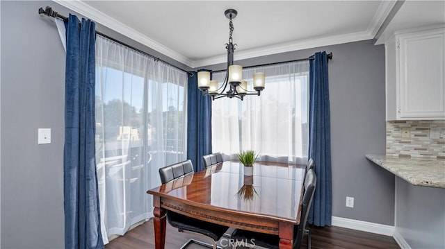 26853 Claudette St Unit 141, Canyon Country, CA 91351 - dining area featuring a chandelier, dark wood finished floors, and ornamental molding