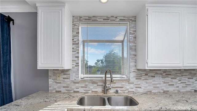 26853 Claudette St Unit 141, Canyon Country, CA 91351 - kitchen with white cabinetry, decorative backsplash, and light stone counters