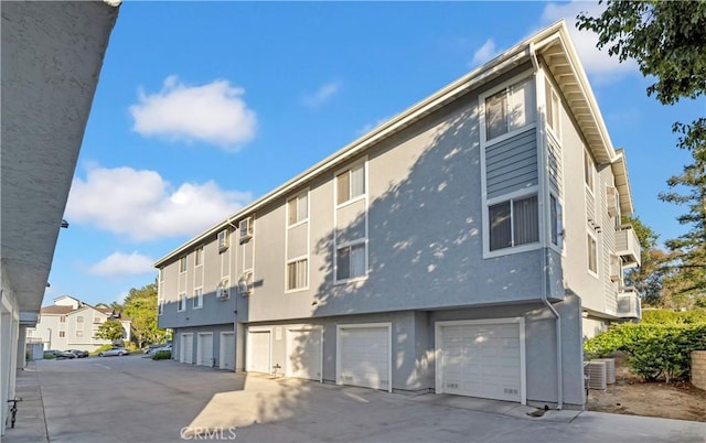 26853 Claudette St Unit 141, Canyon Country, CA 91351 - view of property with concrete driveway, a residential view, and an attached garage