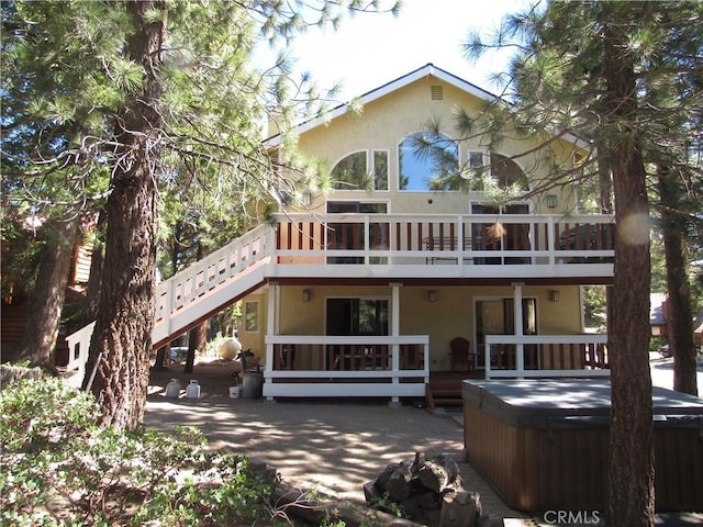 rear view of property featuring a wooden deck