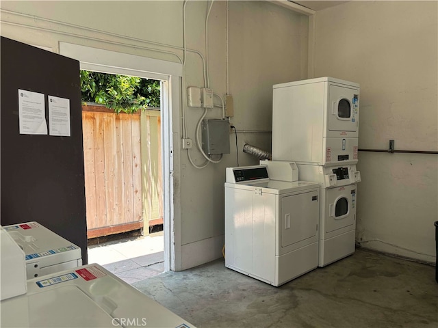 clothes washing area featuring washer and clothes dryer and stacked washer and dryer