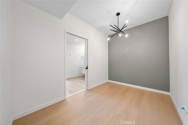 interior space with light hardwood / wood-style flooring and a notable chandelier