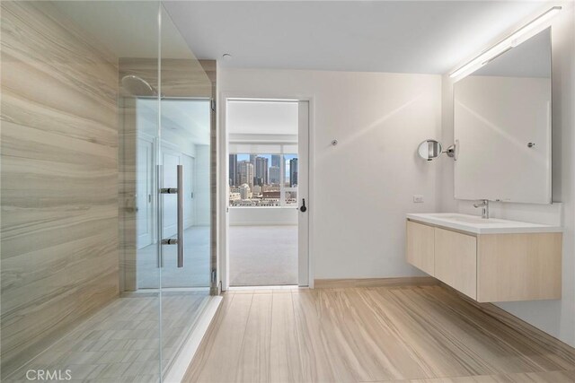 bathroom featuring vanity, tile patterned flooring, and walk in shower