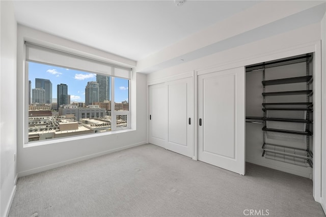 unfurnished bedroom with light colored carpet